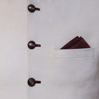 Cream color waistcoat with contrast maroon thread button hole and contrast pocket square