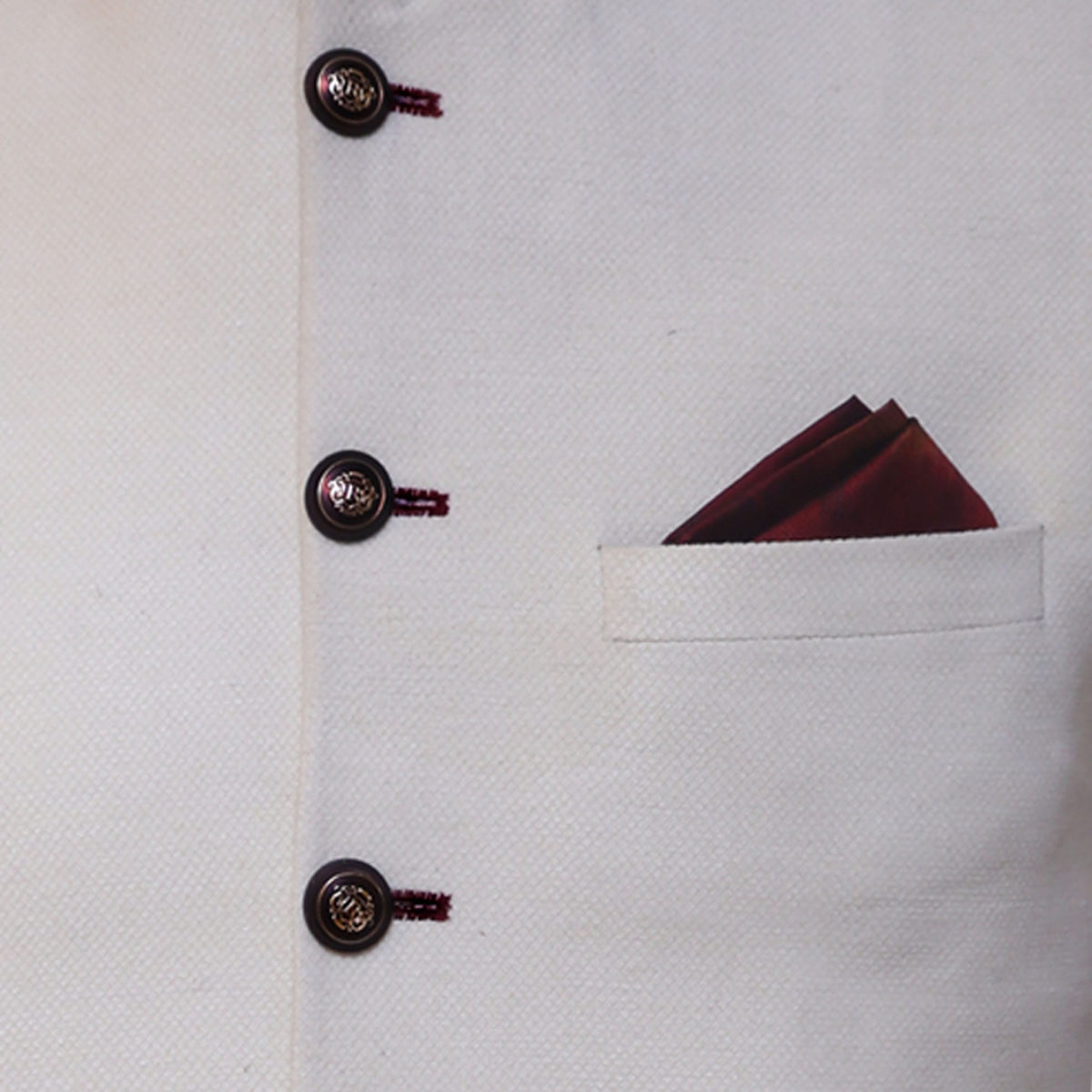 Cream color waistcoat with contrast maroon thread button hole and contrast pocket square