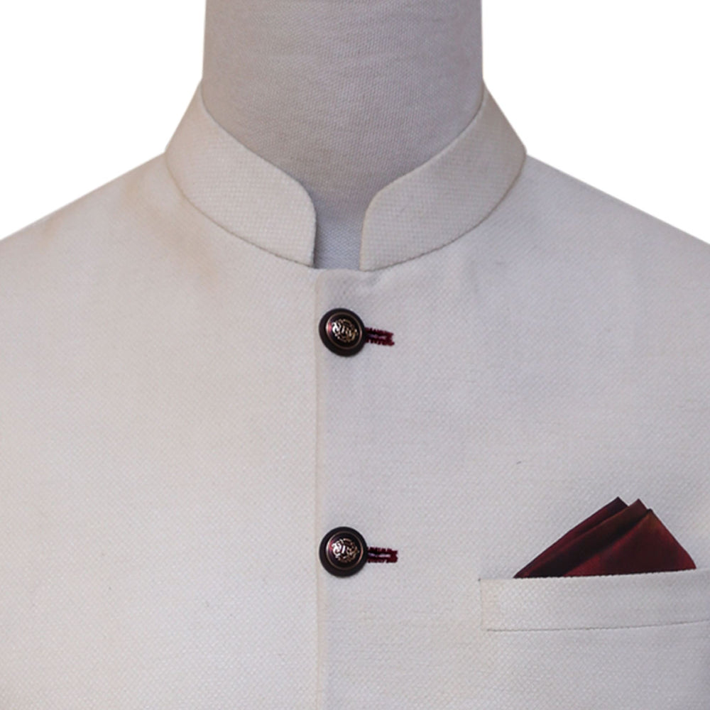 
                  
                    Cream color waistcoat with contrast maroon thread button hole and round ban
                  
                