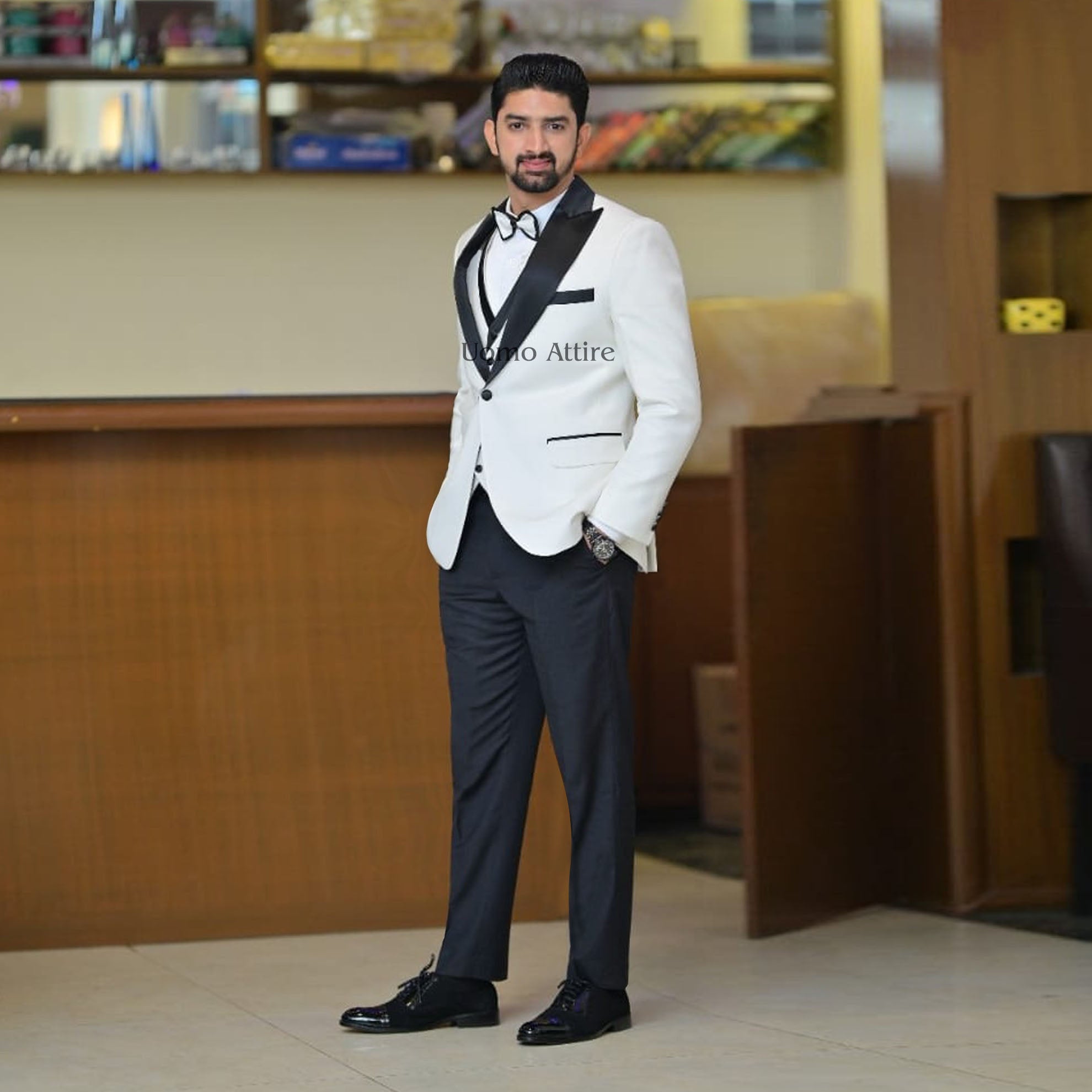 white suit black bow tie