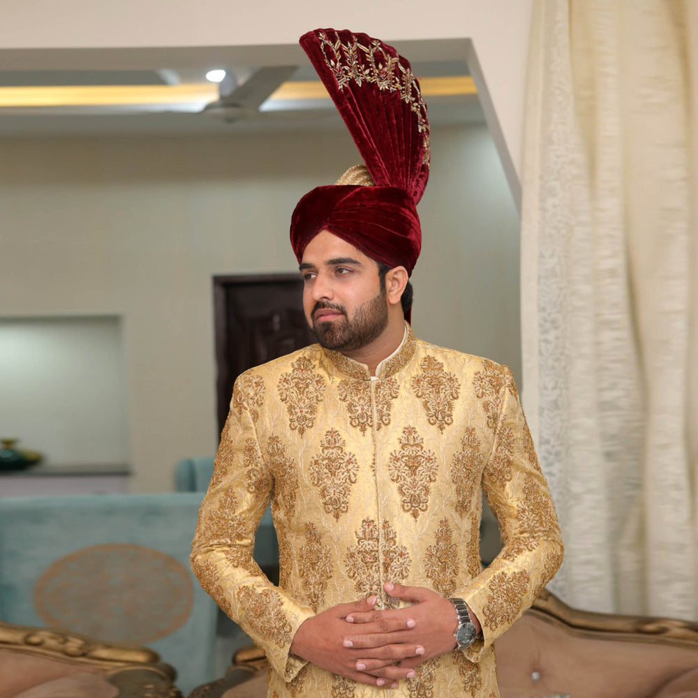 
                  
                    Luxurious Golden Brocade Sherwani with Maroon Velvet Turban
                  
                