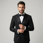 Man wearing a black tuxedo with floral embroidery on a gray background | Bespoke Black Double Breasted Tuxedo Jacket with Leaf Embroidery