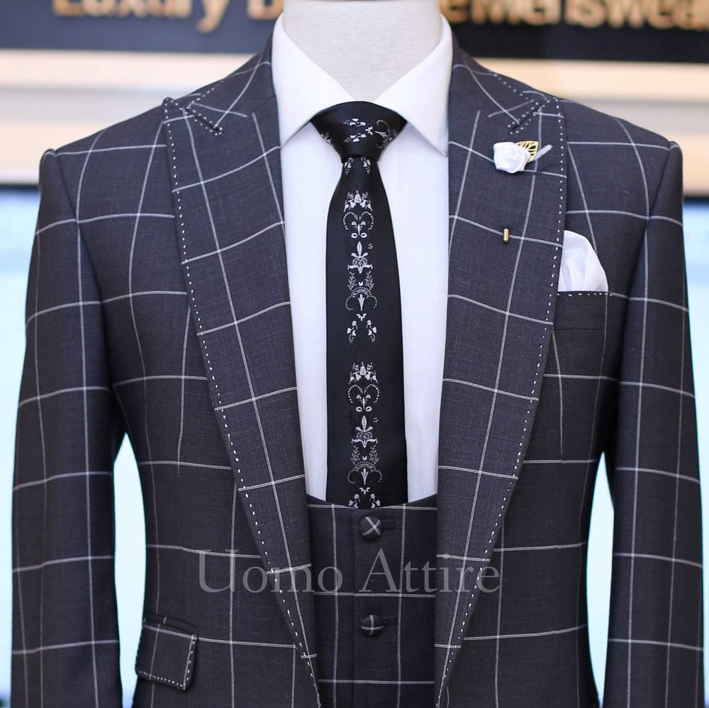 
                  
                    dark grey windowpane check 3 piece suit with single breasted vest and pick stitch
                  
                