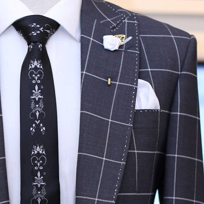 
                  
                    dark grey windowpane check 3 piece suit with pick stitch, lapel pin and designer tie
                  
                