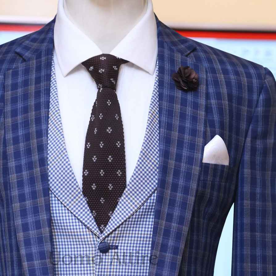 
                  
                    Contrast blue check three piece suit with formal tie and pocket sqaure
                  
                