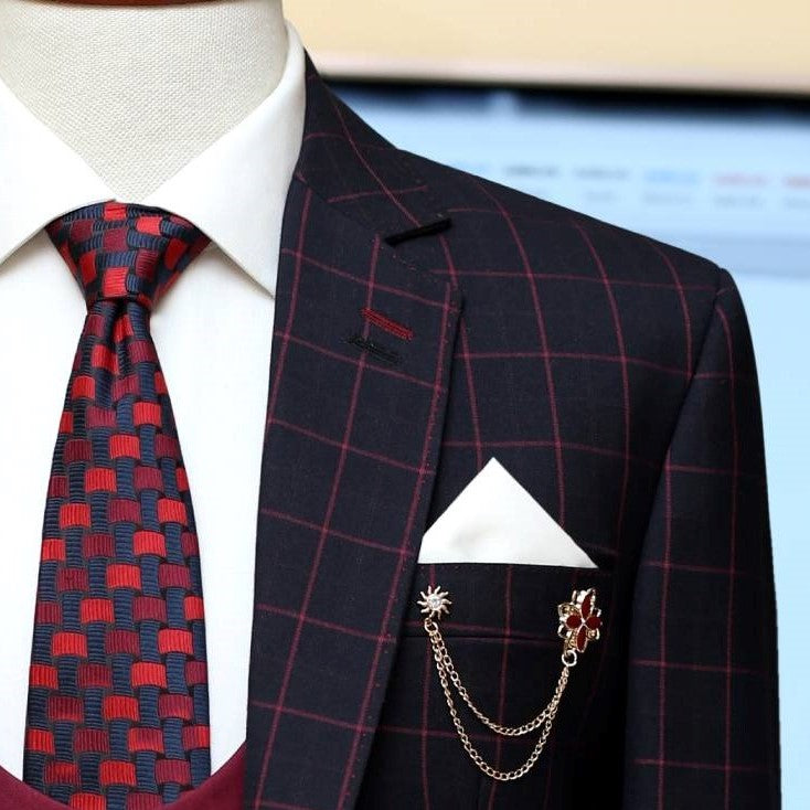 windowpane plain check three piece suit with custom design knitted tie and white pocket square