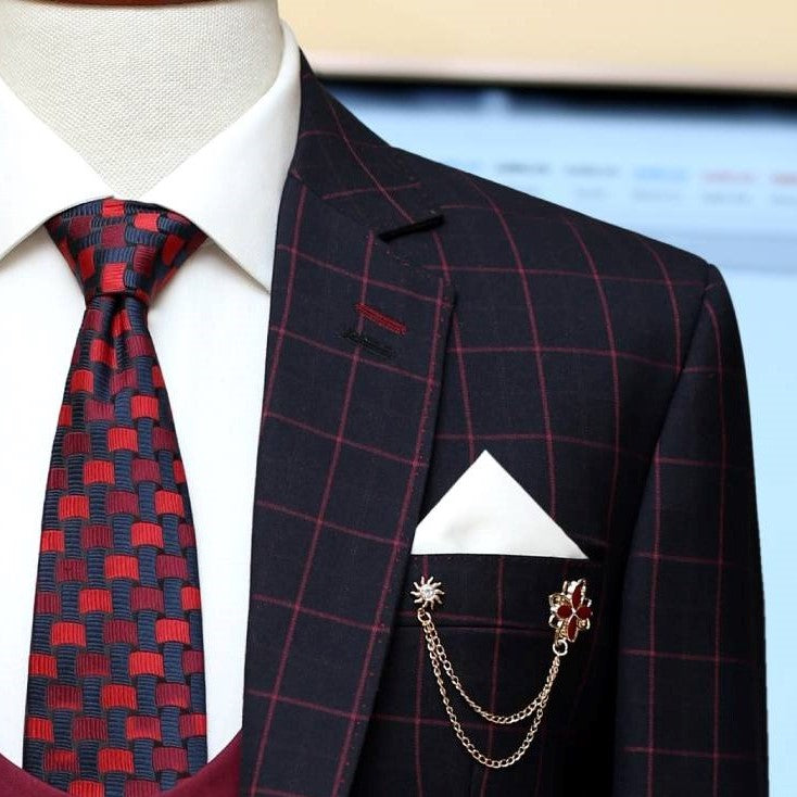 
                  
                    windowpane plain check three piece suit with custom design knitted tie and white pocket square
                  
                